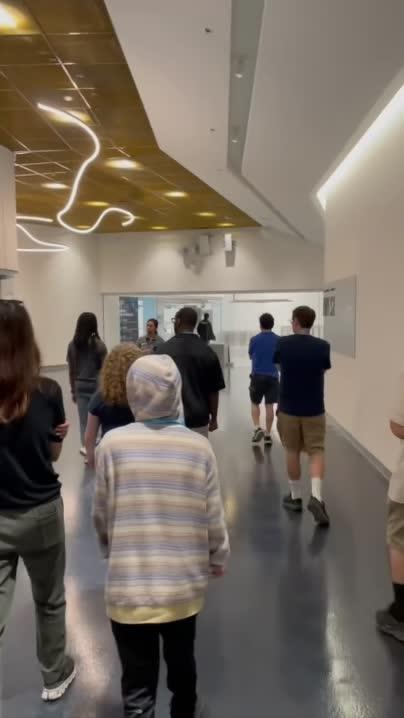 People walking together inside SoFi Stadium.